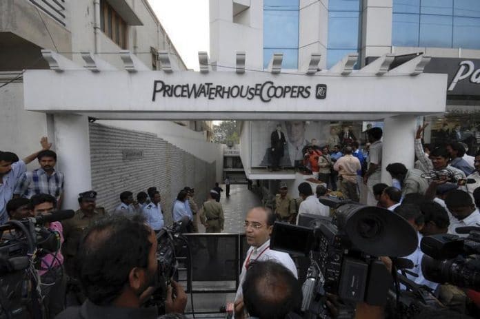 Media persons and policemen gather outside office of PWC in Hyderabad