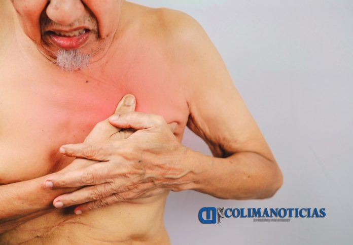 senior man is clutching he chest. possible heart attack